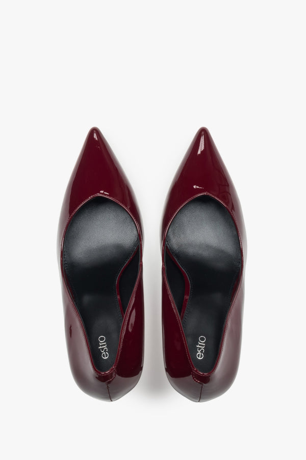 On a high heel, dark red women’s shoes made of patent leather Estro.
