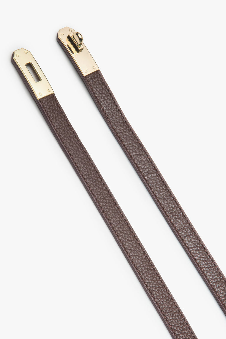 Women's burgundy leather belt with gold accents.