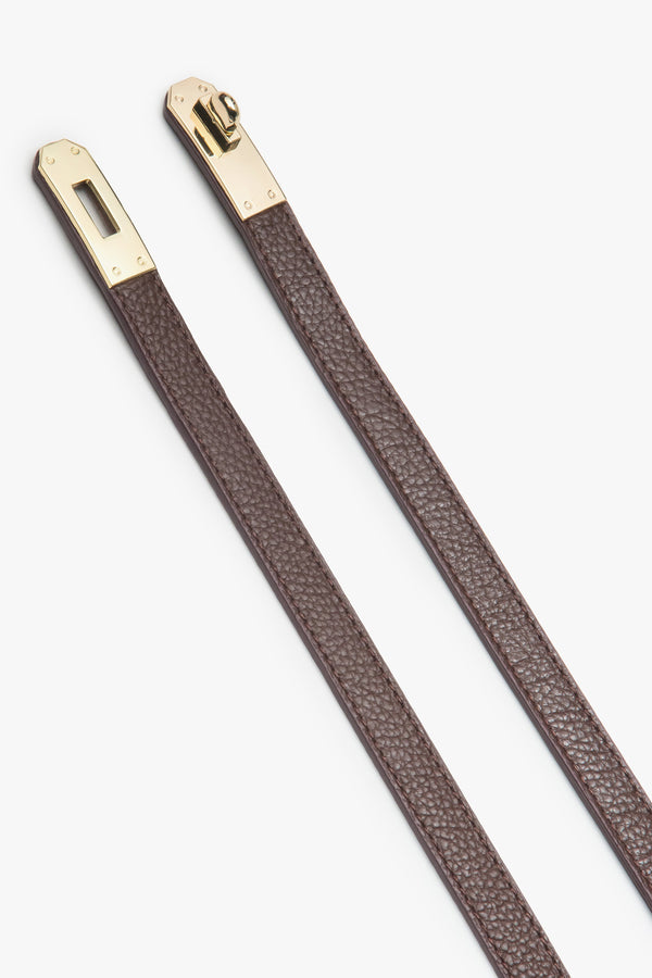 Women's burgundy leather belt with gold accents.