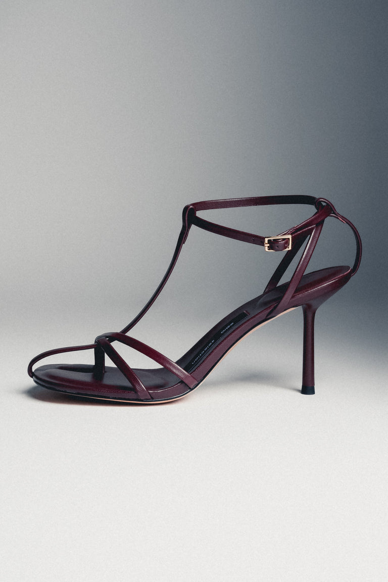 Low side view of women's burgundy leather high heel sandals