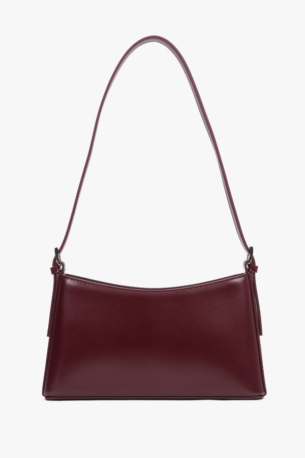 Front view of burgundy leather shoulder bag with silver-toned hardware.