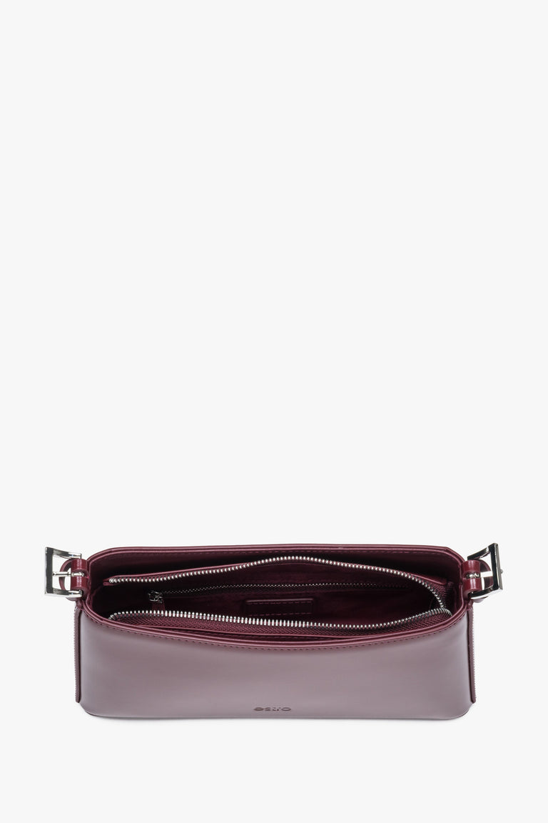 Top view of burgundy shoulder bag with zipper closure and compact shape.