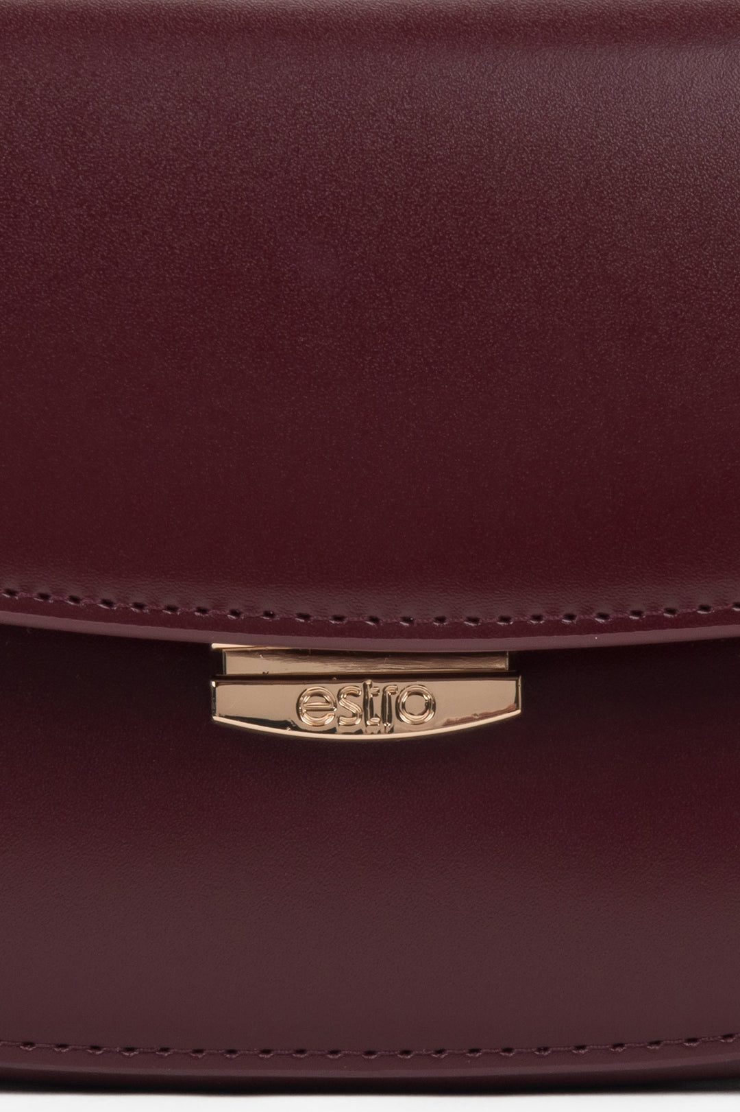 Burgundy leather saddle-style shoulder bag with additional adjustable strap.