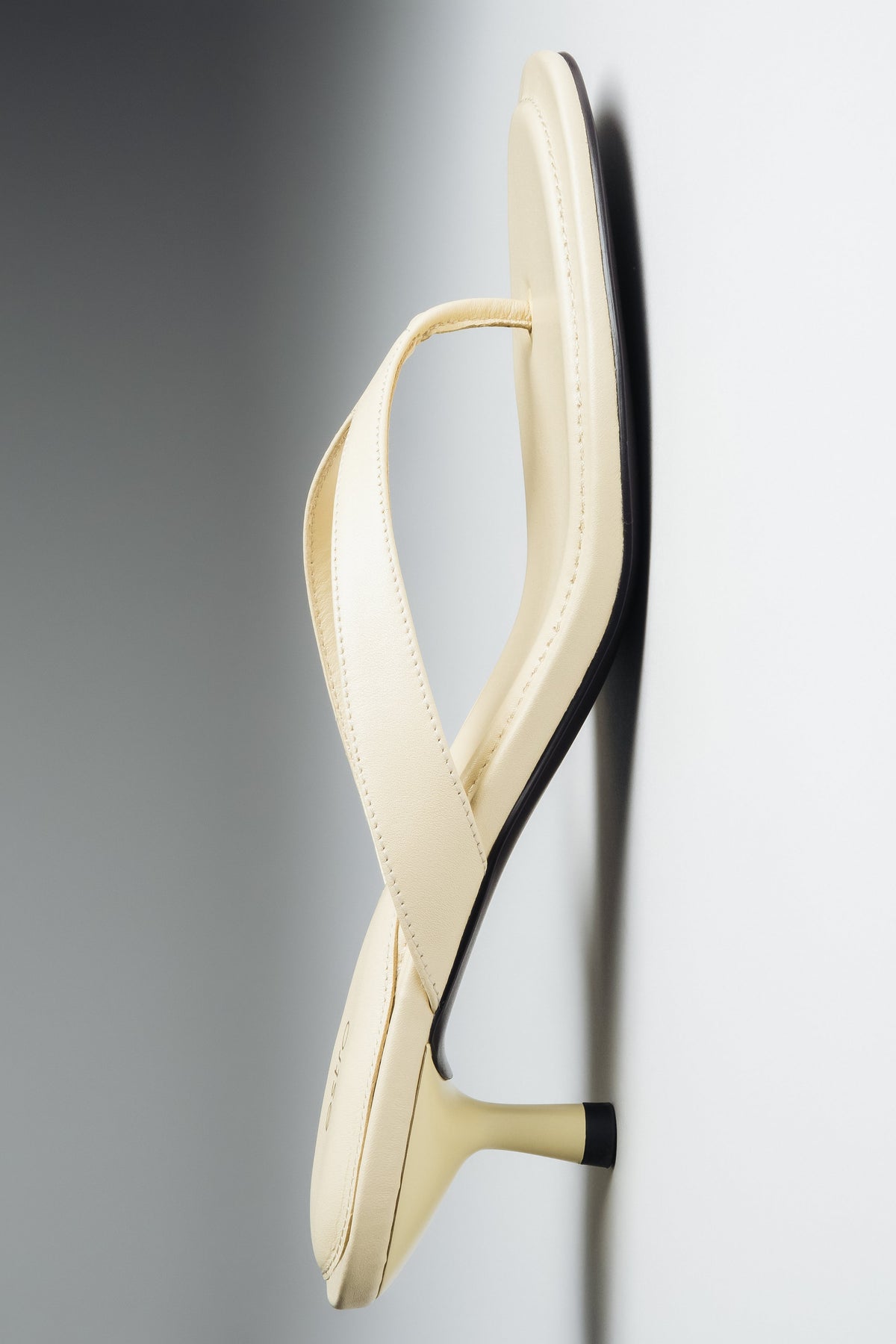 Flat lay view of women's butter yellow leather mules by Estro