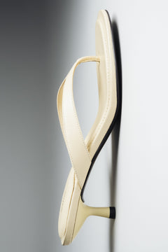 Flat lay view of women's butter yellow leather mules by Estro