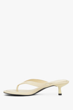 Side profile of women's butter yellow kitten heel mules by Estro