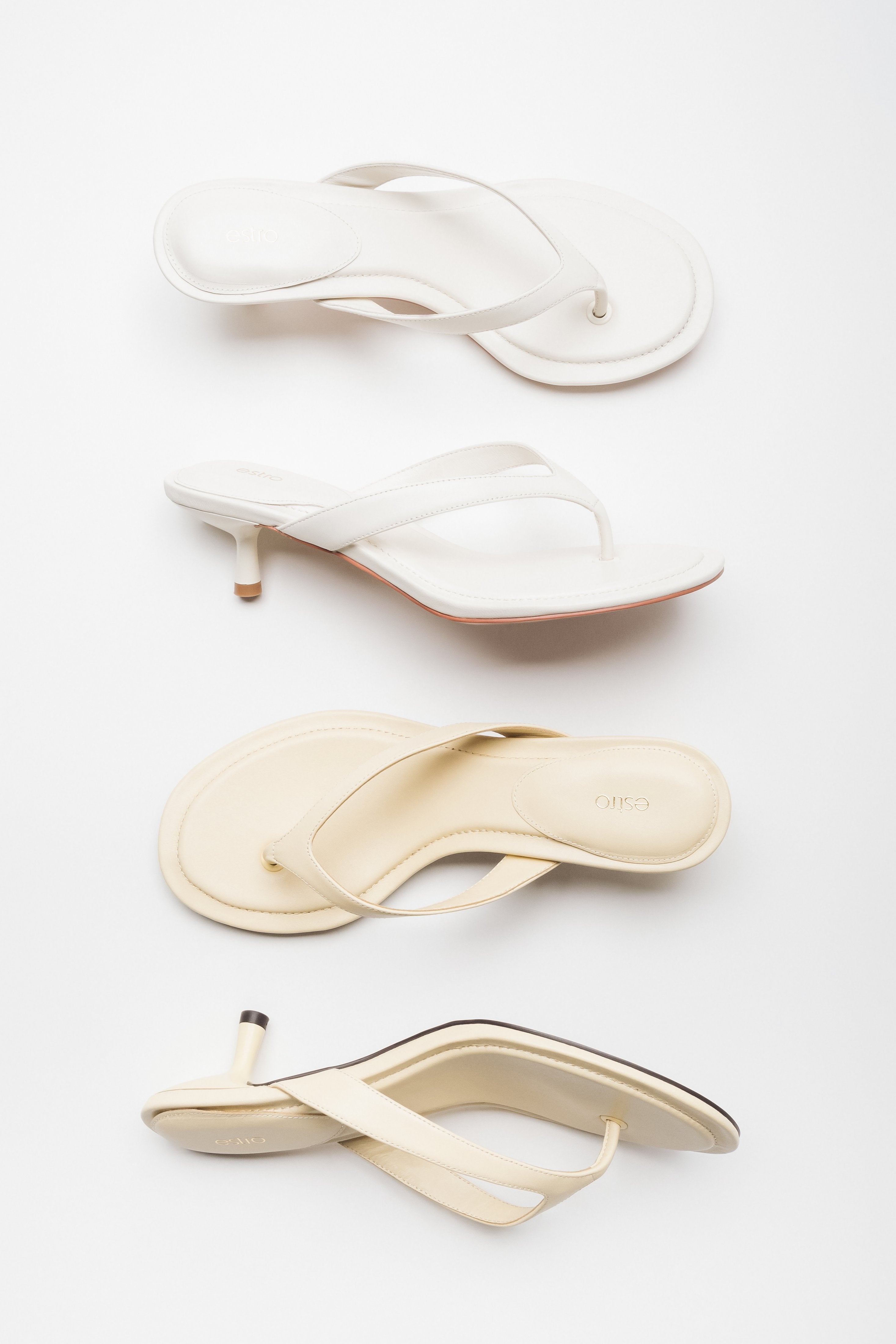 Two light colour versions of women's thong-style mules by Estro