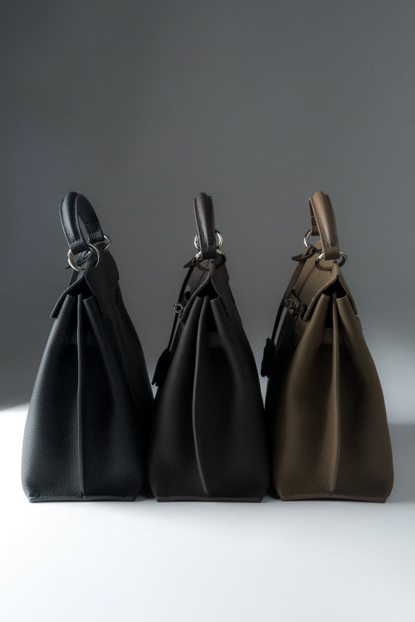 Women’s taupe genuine leather satchel bag by Estro – color comparison.