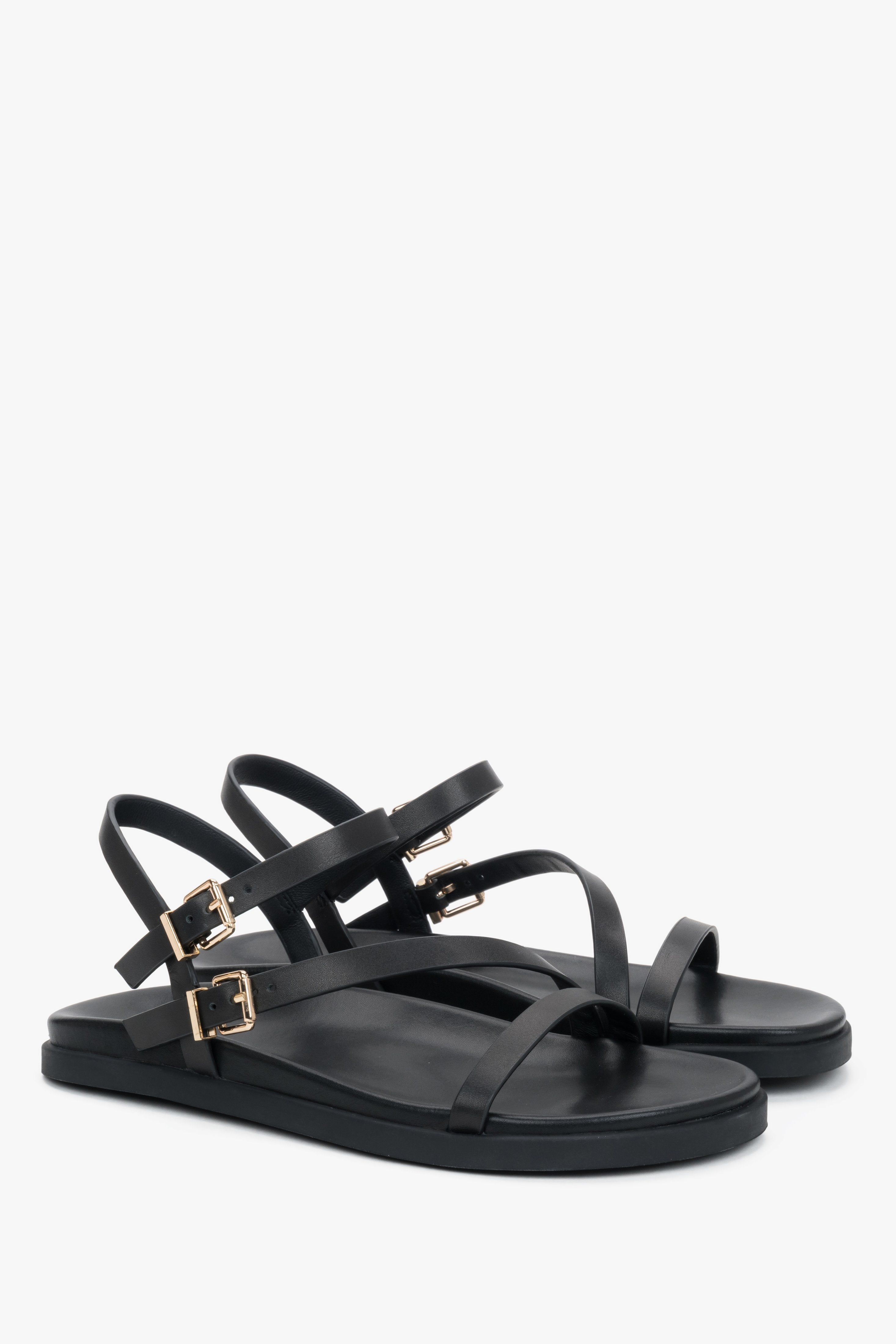 Comfortable women’s black leather sandals with thin straps.
