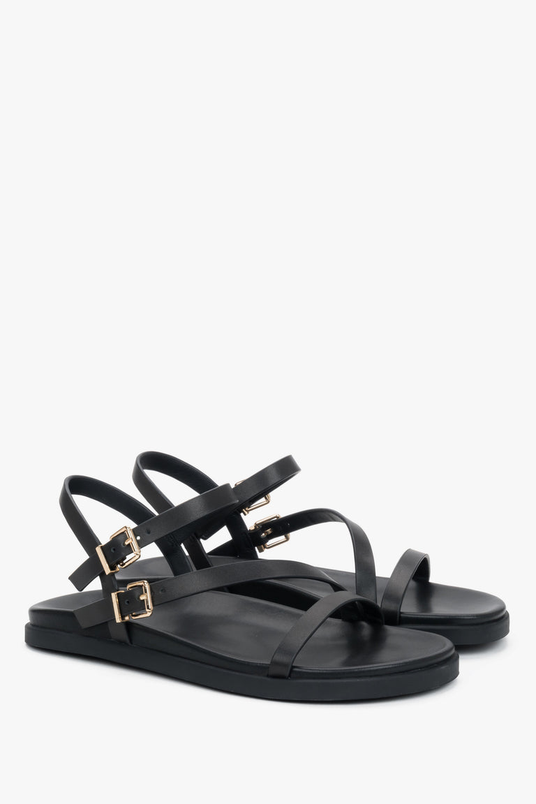 Comfortable women’s black leather sandals with thin straps.
