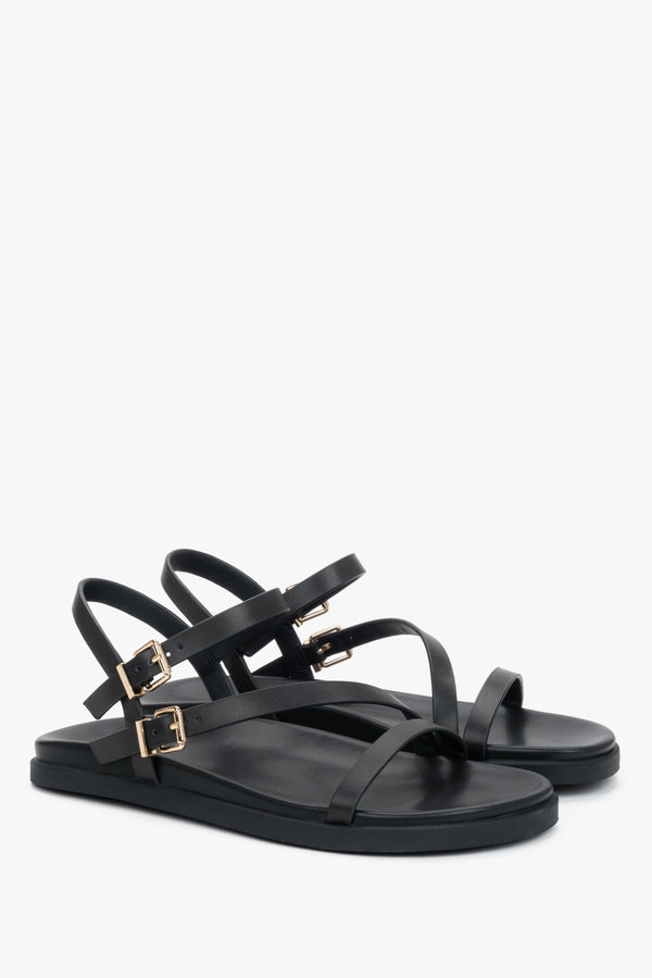 Comfortable women’s black leather sandals with thin straps.
