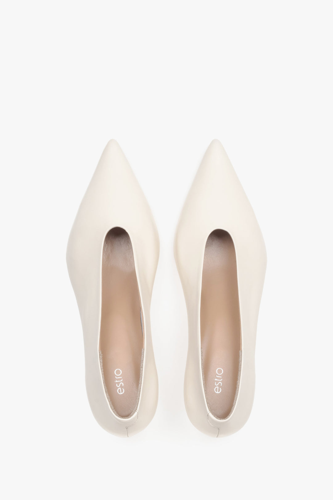 Top view of women’s cream beige leather kitten heels with pointed toe.
