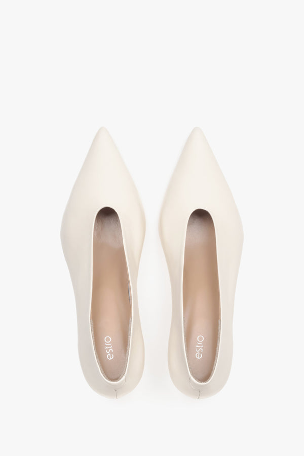 Top view of women’s cream beige leather kitten heels with pointed toe.