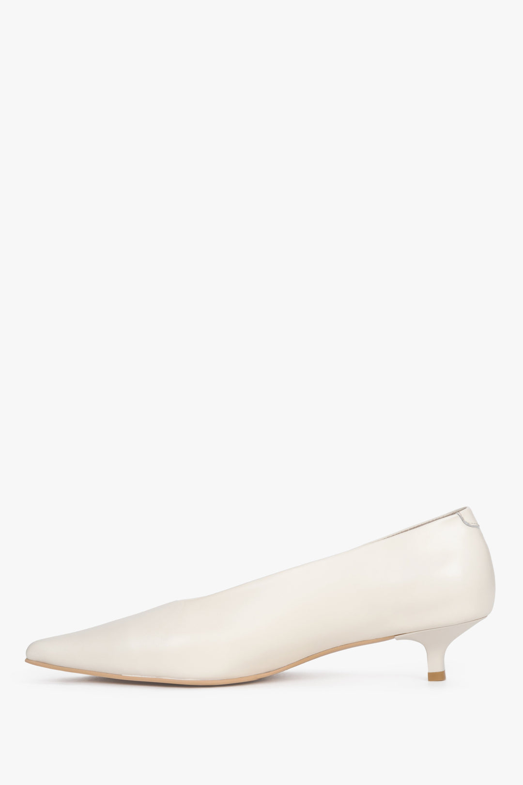 Side view of the pointed toe and smooth leather trim on cream and beige kitten heel sandals.