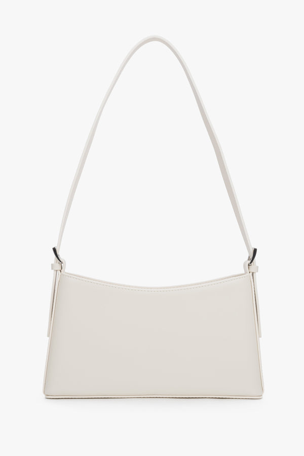 Front view of a cream beige leather shoulder bag with silver-toned hardware.