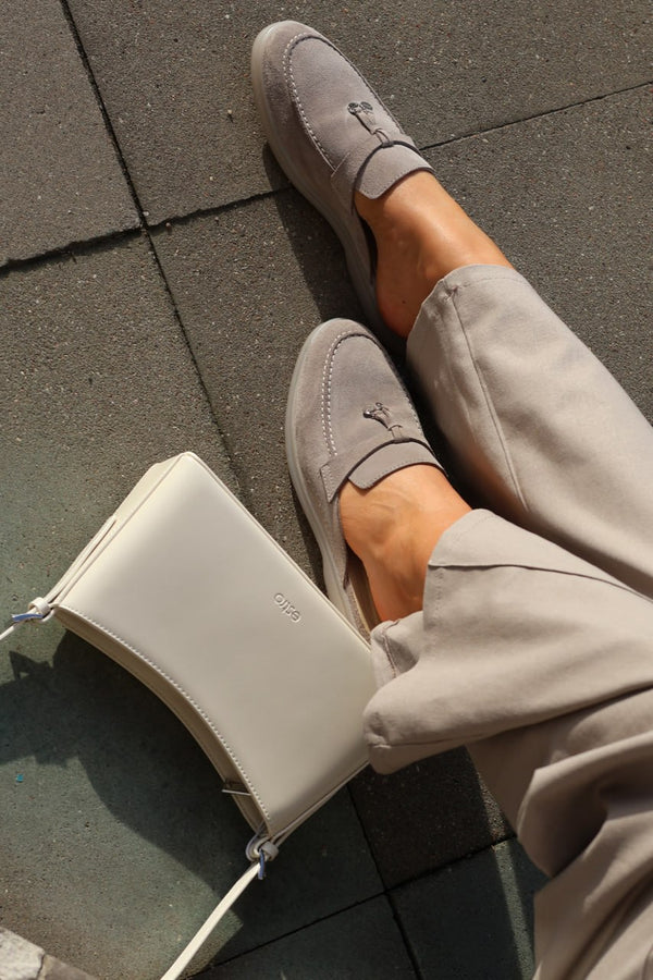 Branded dust bag included with the Estro cream beige leather shoulder bag.