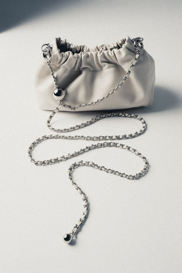 Top view of women's cream beige leather shoulder bag with drawstring