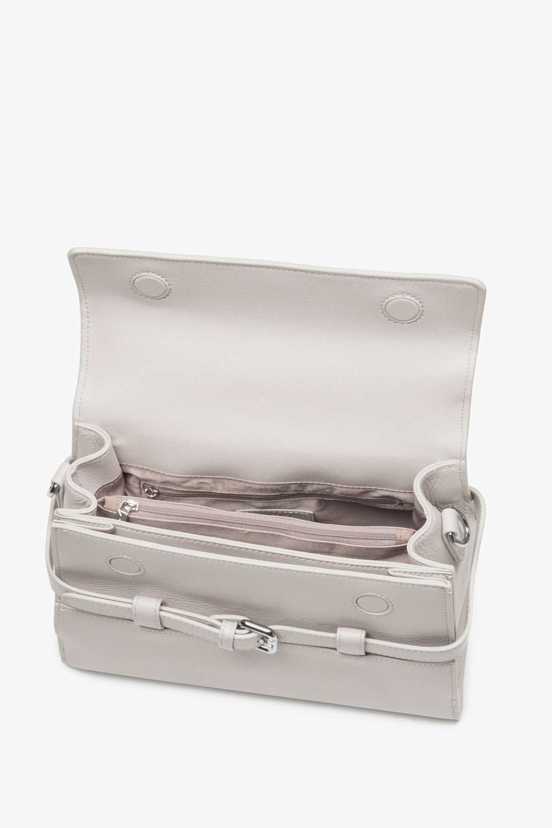 Interior view of women's cream beige leather shoulder bag with compartments.