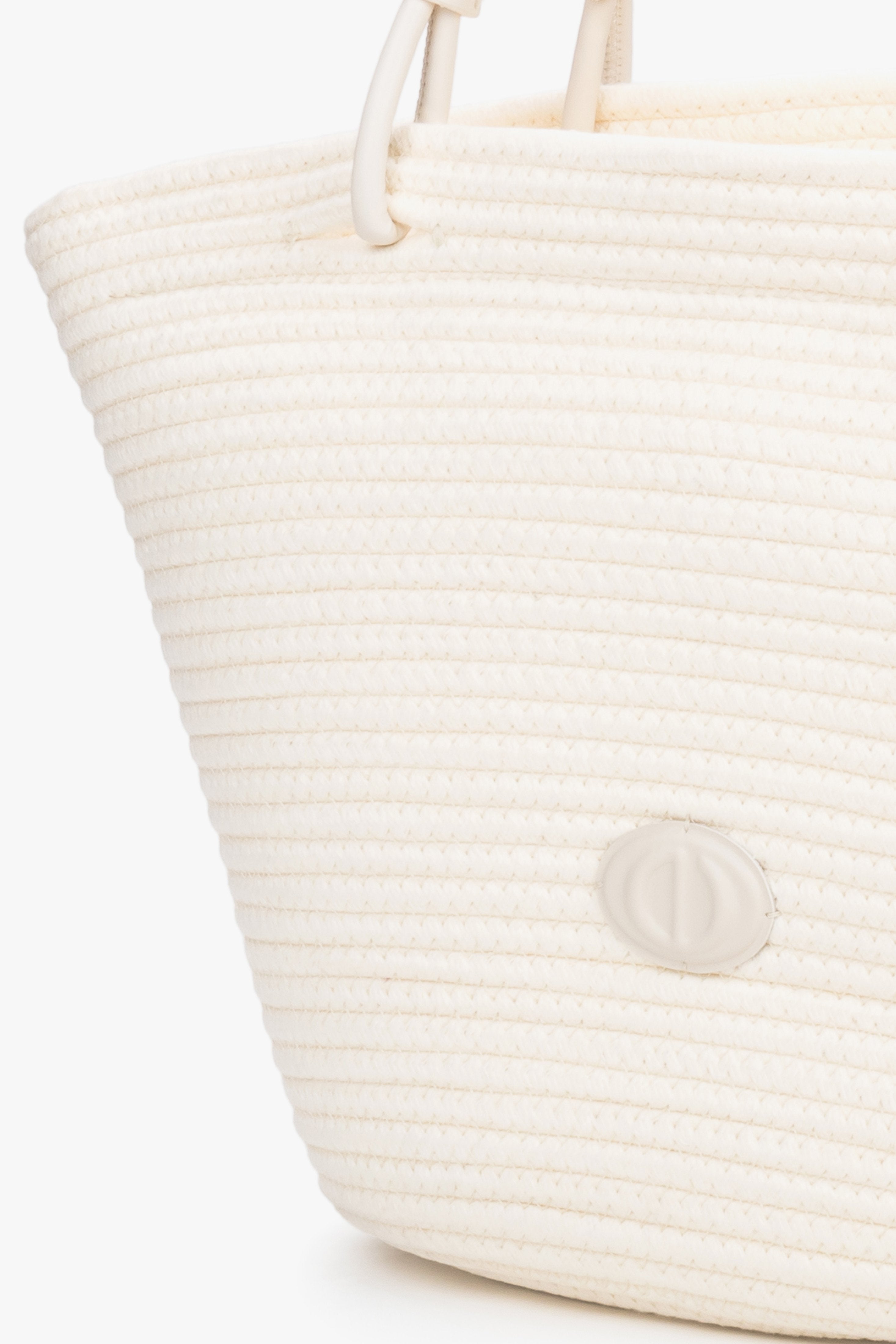Detail view of cream beige textile shopper bag with straw-like texture