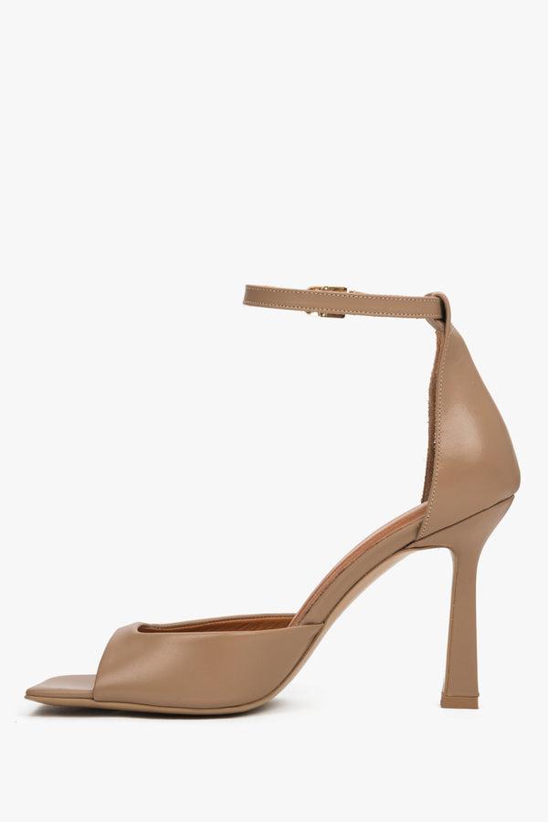 Beige women’s genuine leather sandals featuring an architectural silhouette and a stable 10 cm flared heel.