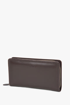 Close-up detail of the genuine leather texture and embossed logo, emphasizing premium quality and craftsmanship.