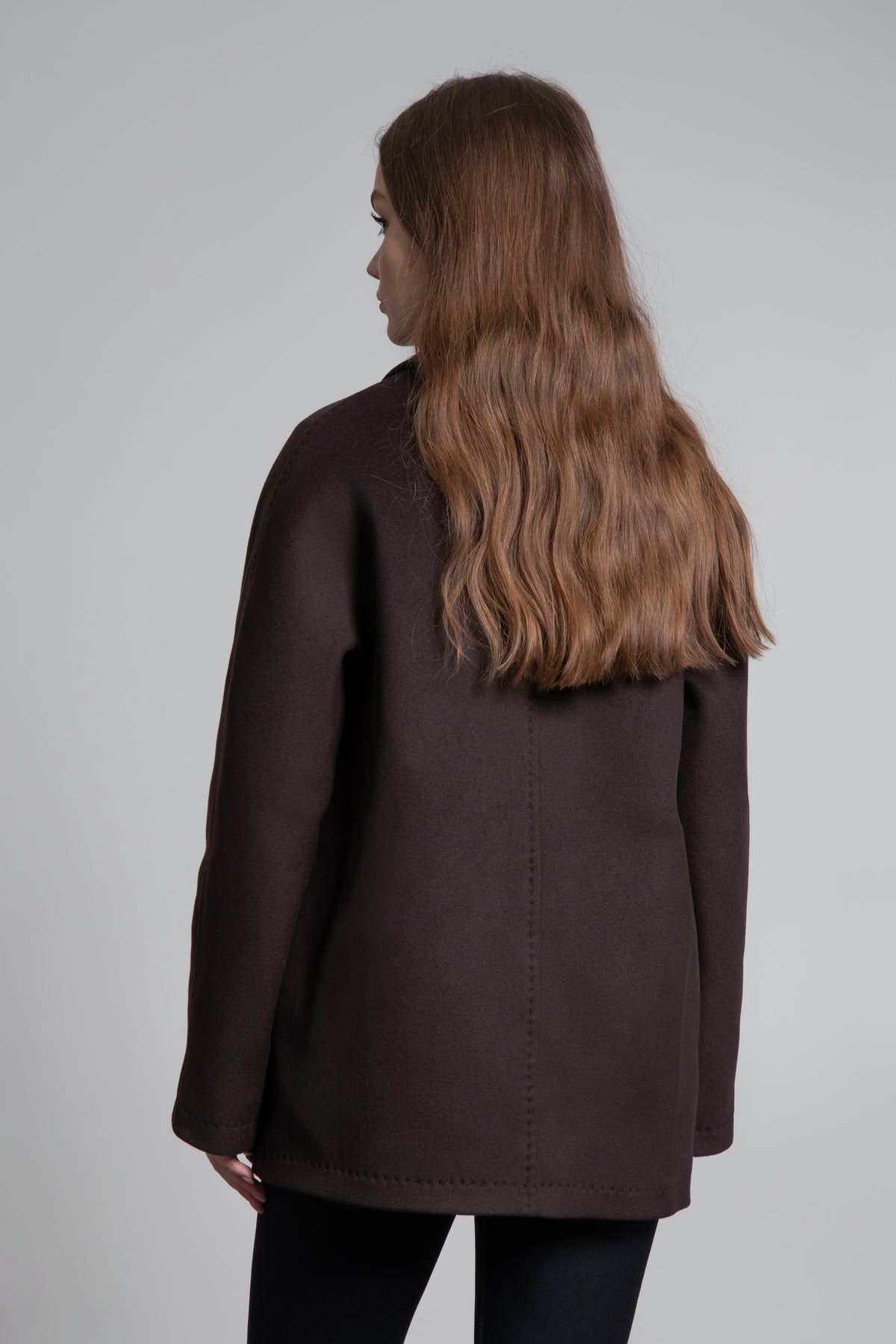 A dark brown short wool coat for women, featuring a classic double-breasted closure by Estro.