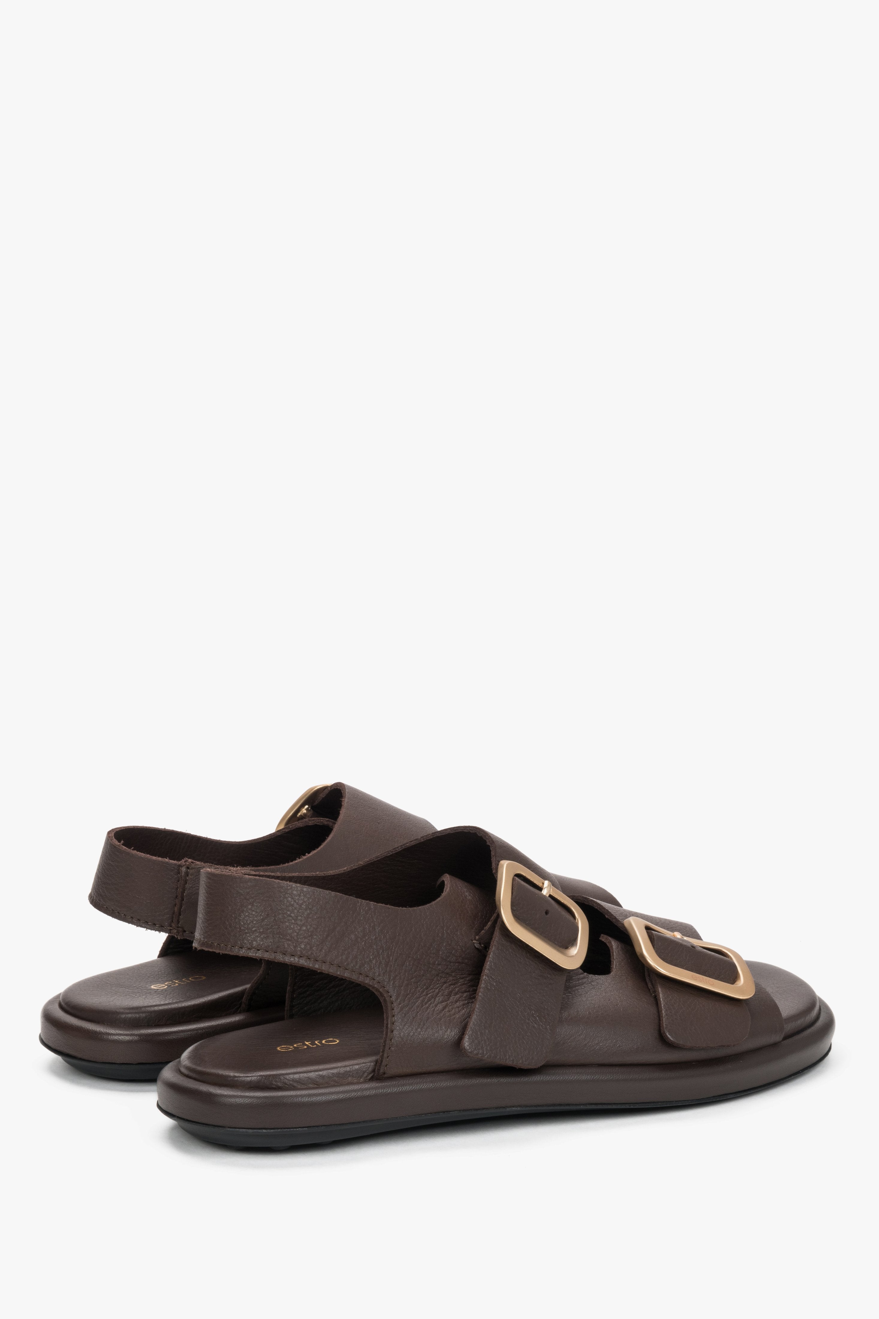 Women’s dark brown Estro flat sandals with adjustable gold-tone buckles.