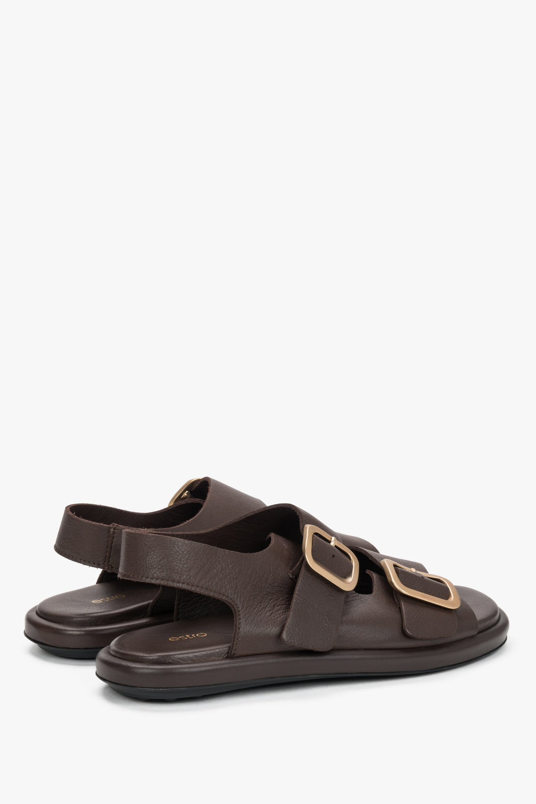 Women’s dark brown Estro flat sandals with adjustable gold-tone buckles.