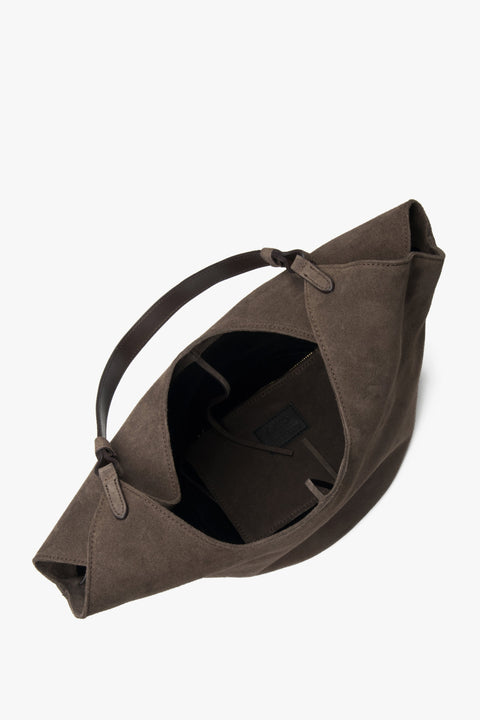 The bag opens to reveal two roomy compartments and two interior pockets, ideal for organizing essentials with ease.