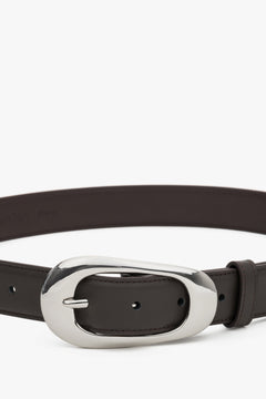 Close-up of smooth dark brown leather texture.