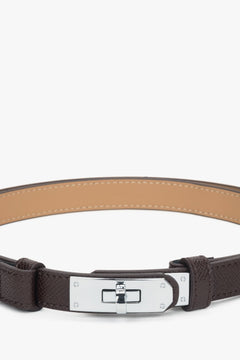 Women's dark brown leather belt with a silver buckle.