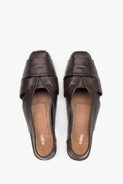View from above of dark brown leather flat sandals.