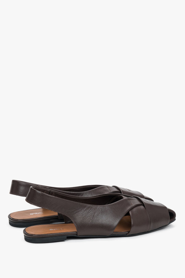 Dark brown closed-toe leather sandals.