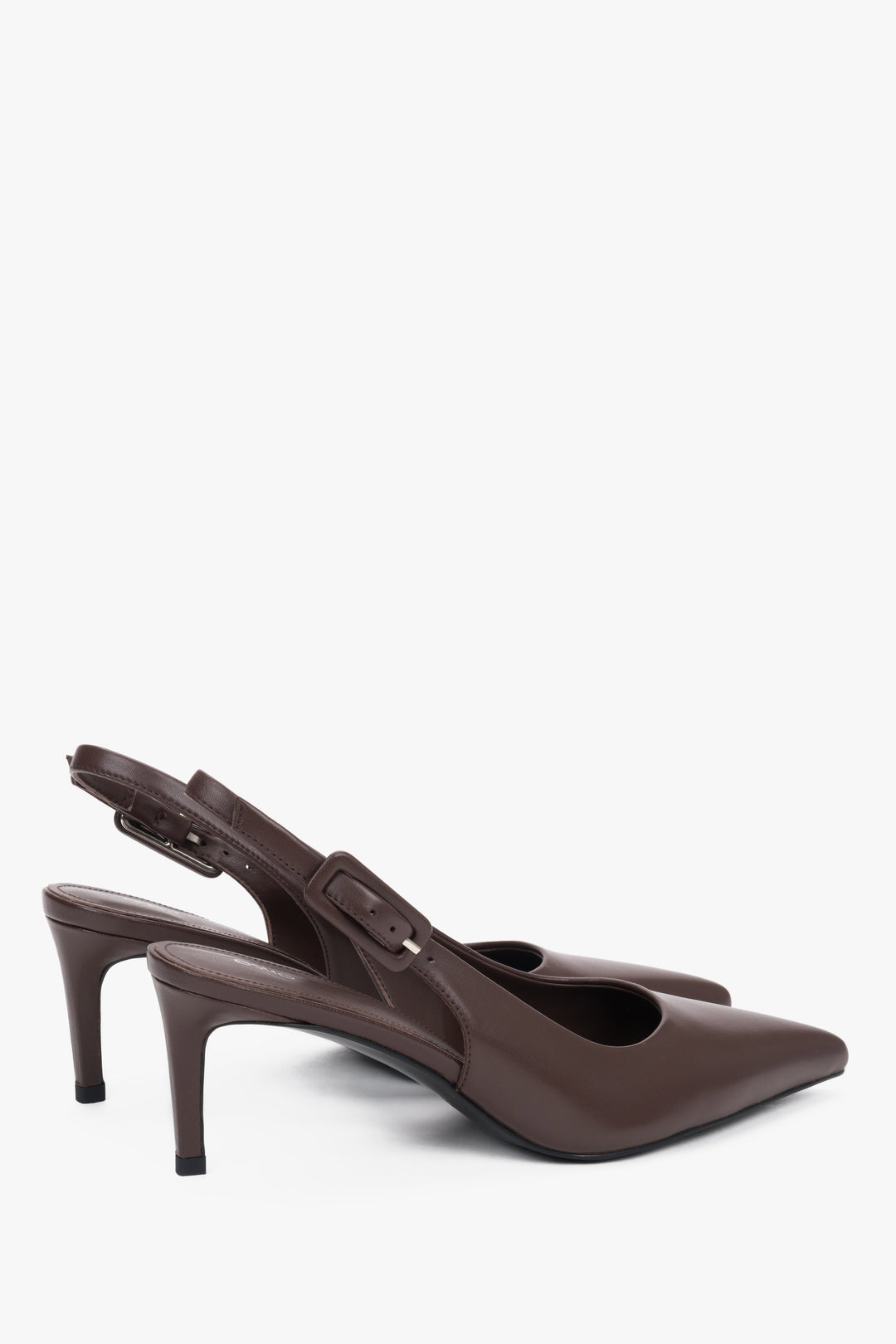 Close-up of the pointed toe and silver-tone buckle on dark brown leather pumps.
