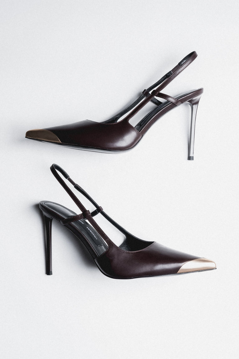 Side view of women's dark brown leather slingback stilettos with gold pointed toe