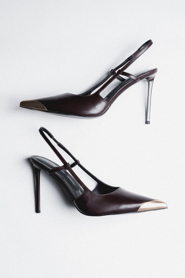 Side view of women's dark brown leather slingback stilettos with gold pointed toe