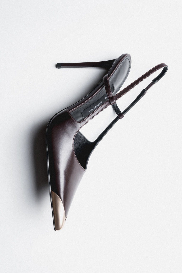Angled view of women's dark brown leather slingback stilettos with slim heel