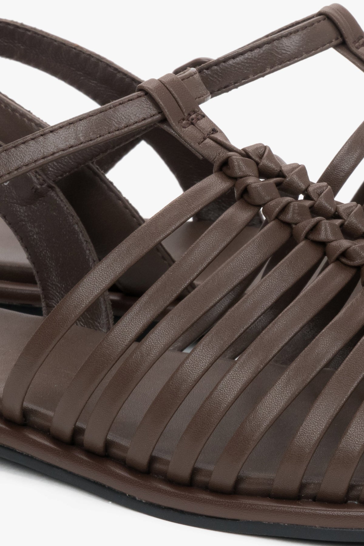 Flat dark brown summer sandals with thin leather straps and buckle closure.