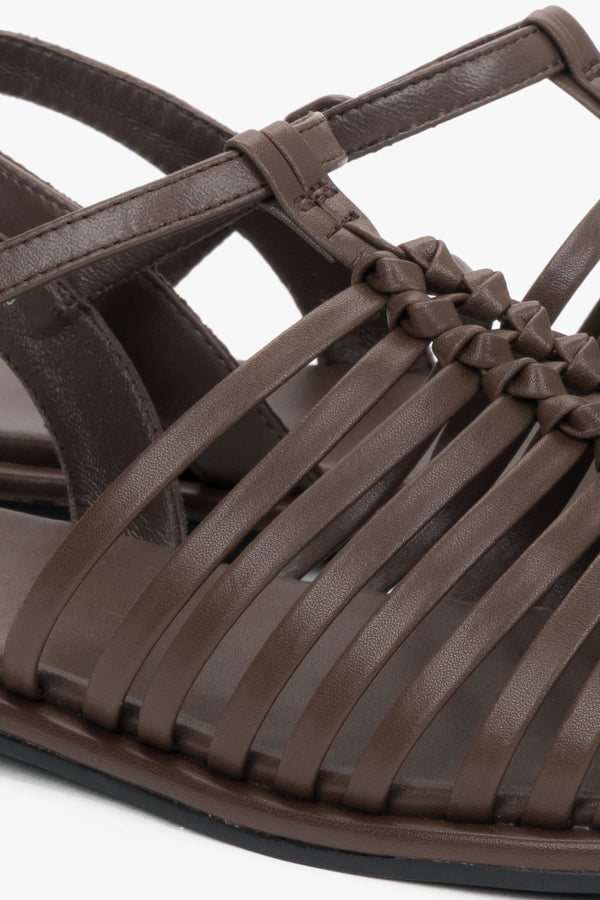 Flat dark brown summer sandals with thin leather straps and buckle closure.