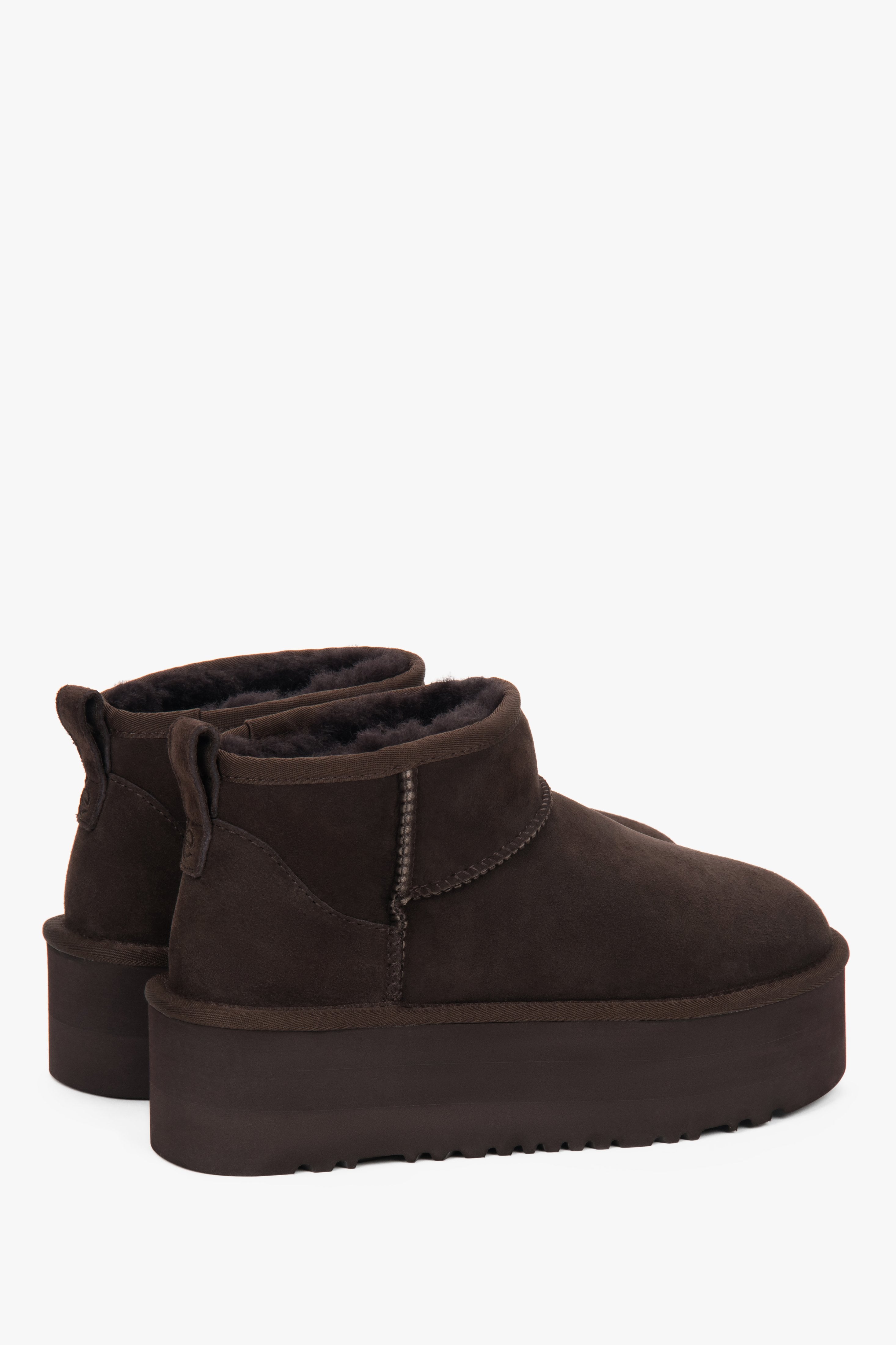 On a thick sole — dark brown women’s snow boots made of genuine velour with fur lining, Estro.