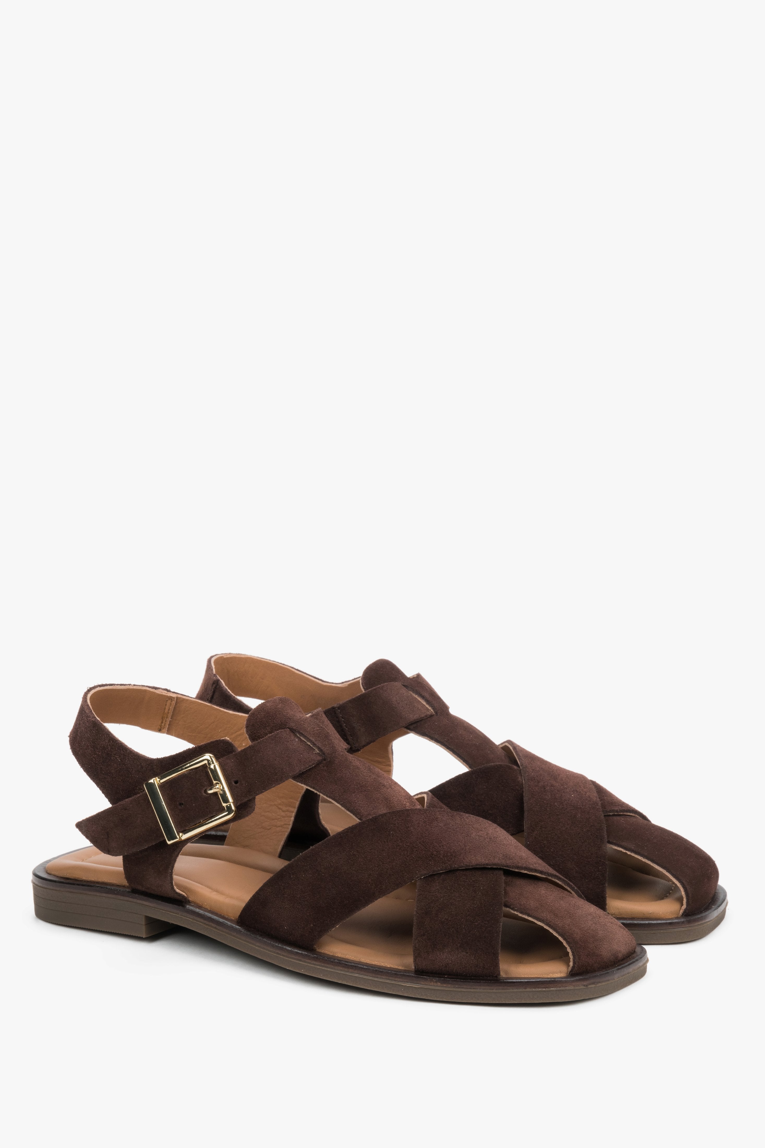Women’s dark brown Estro sandals made of natural suede with crisscross straps and a buckle.