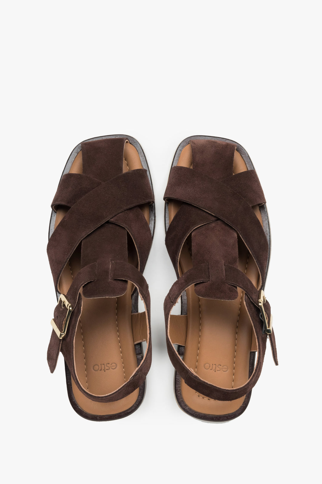 Dark brown Estro women’s sandals made of natural suede with crisscross straps and a buckle.