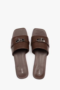 Classic dark brown Estro women's slide sandals, refreshingly accented with a silver embellishment — perfect for summer and comfortable thanks to the flat sole.