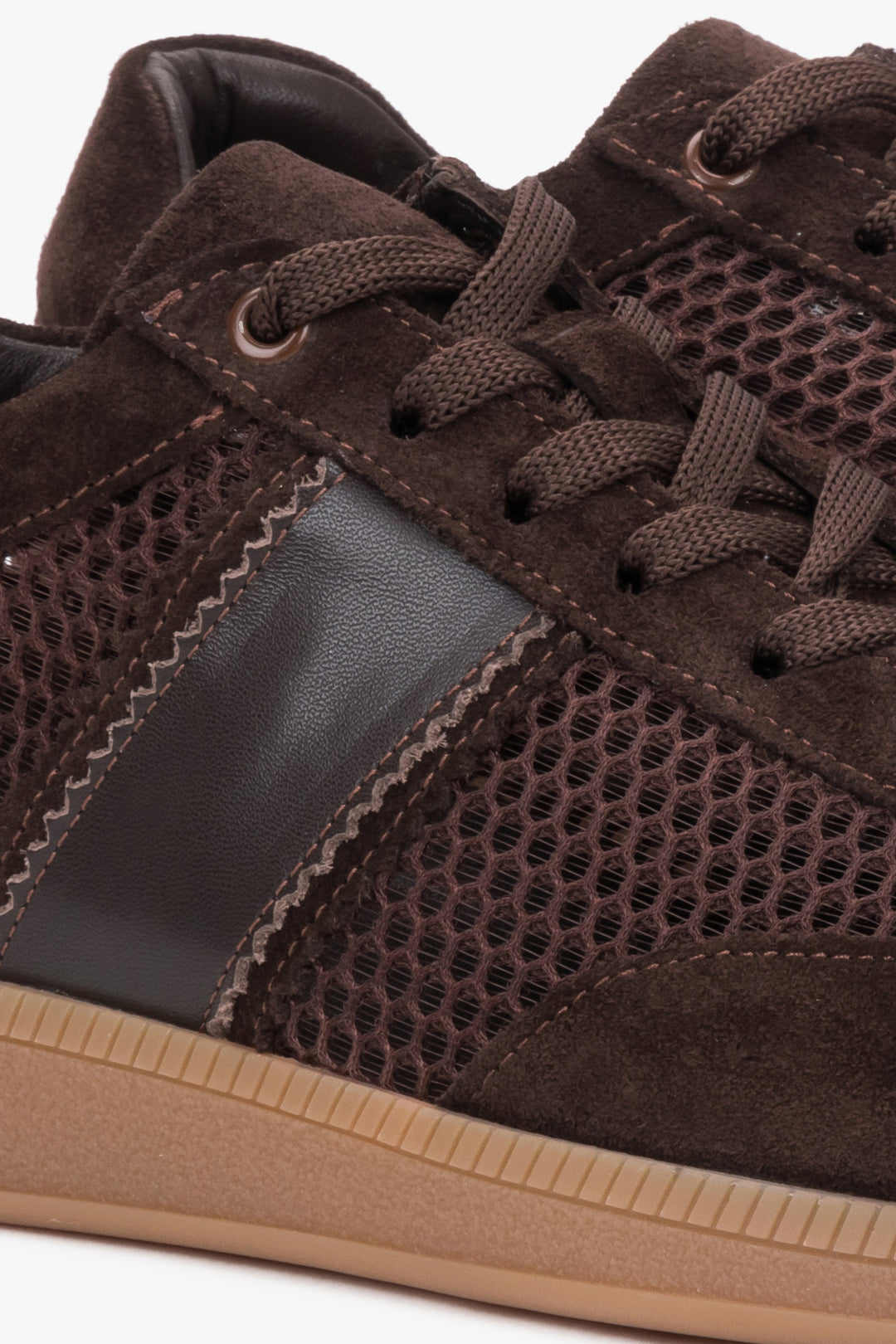 Detail of the sole on dark brown mesh and velour sneakers.
