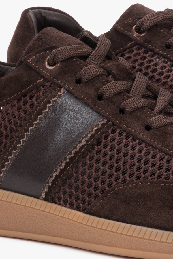 Detail of the sole on dark brown mesh and velour sneakers.