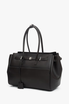 Spacious leather satchel with three compartments and silver hardware, designed to fit A4 and keep essentials organized.