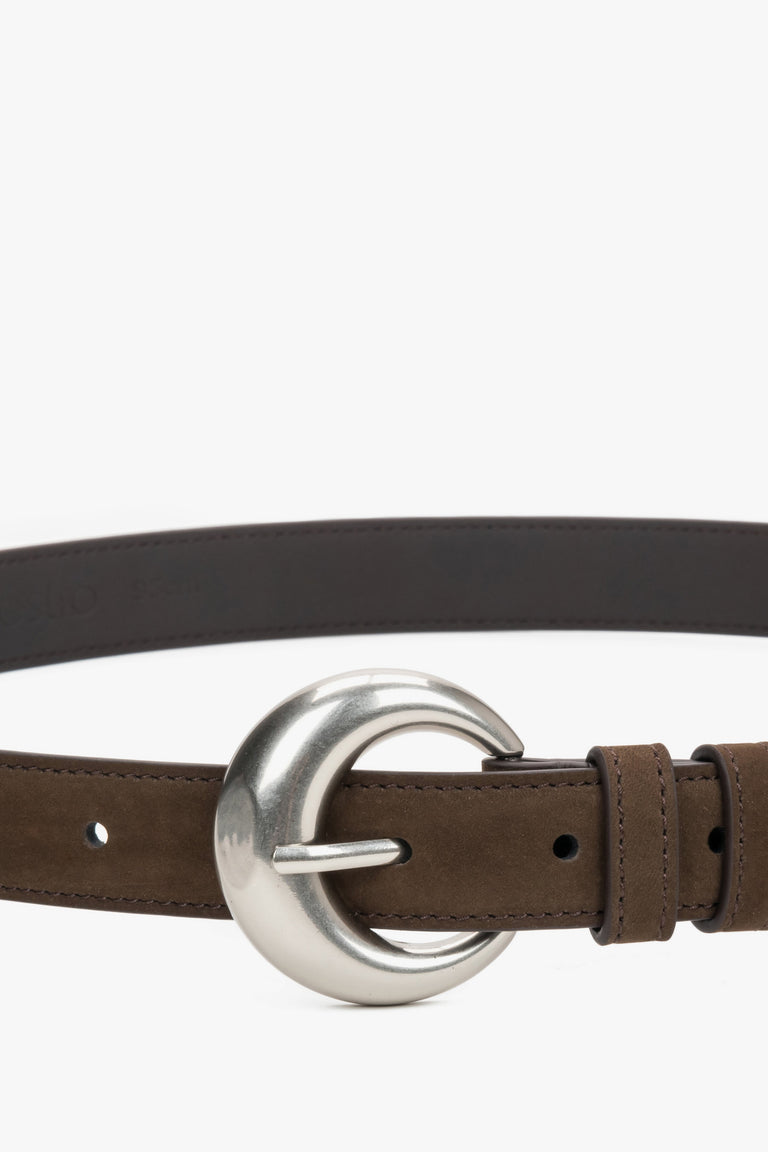 Close-up of the rounded silver buckle on a brown belt.