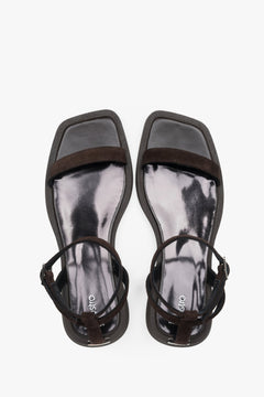 Top view of women’s dark brown flat sandals with slim velour straps.