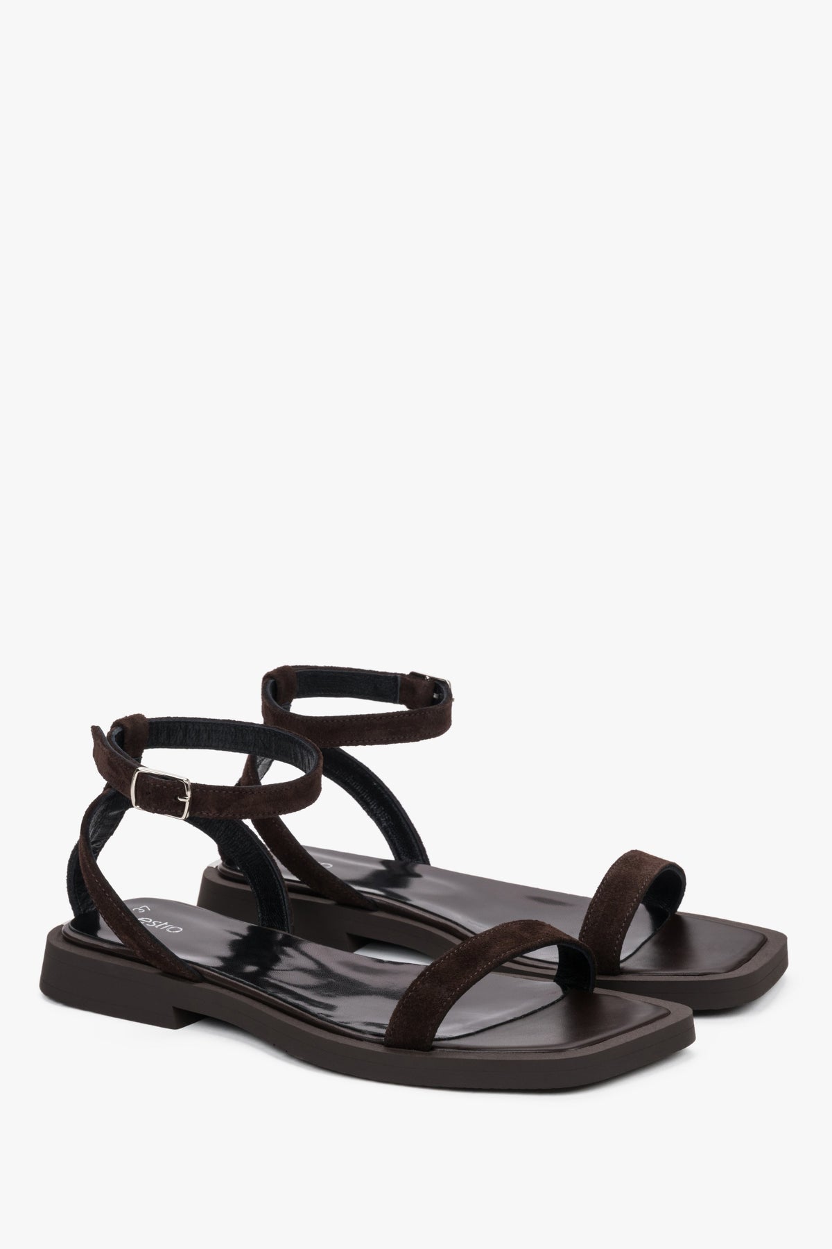 Detail view of the thin straps and soft dark brown velour on Estro sandals.