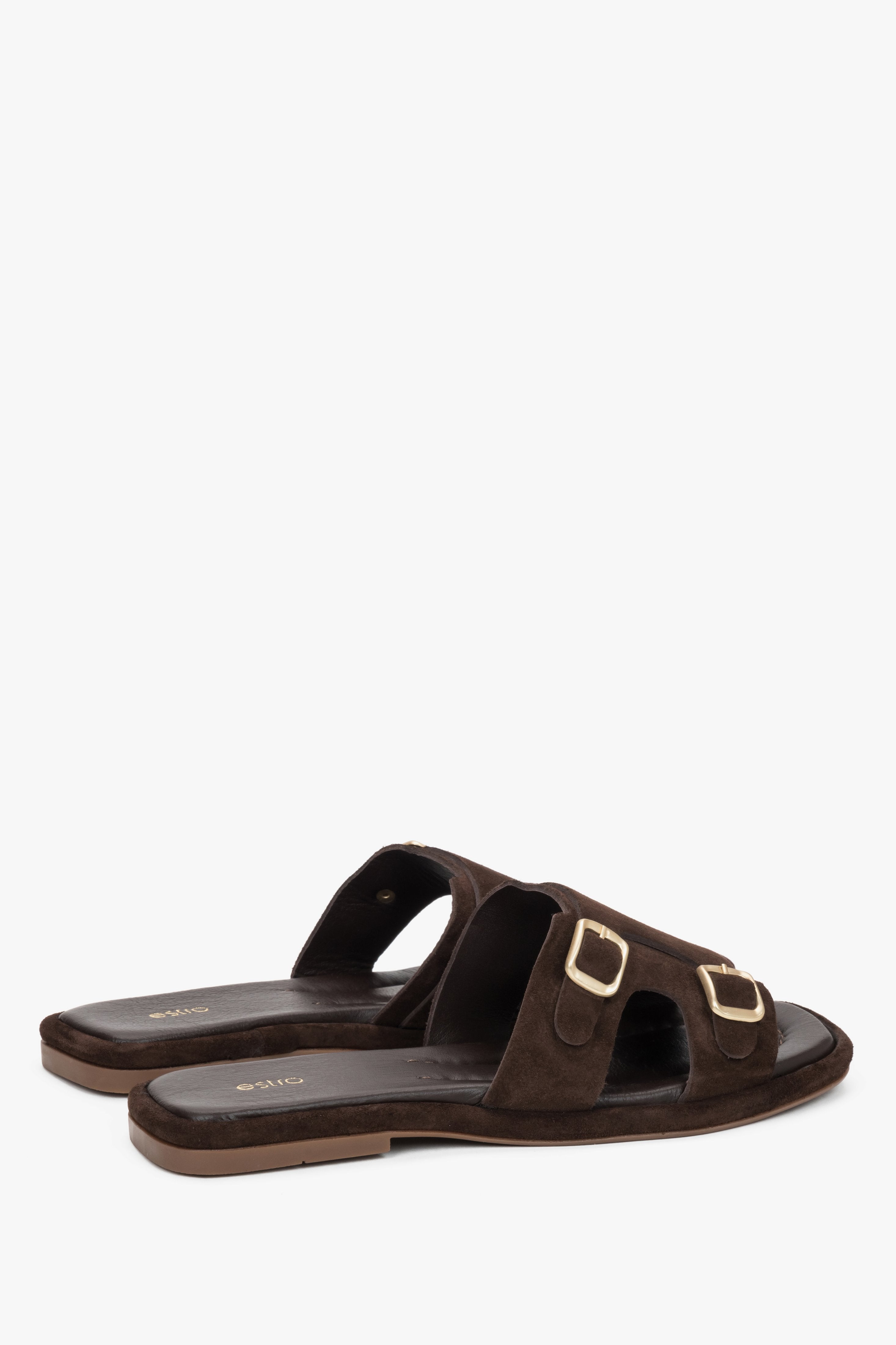 The back of the shoe showing the clean cuts, precise stitching, and stable low platform profile of these luxury vacation slides.